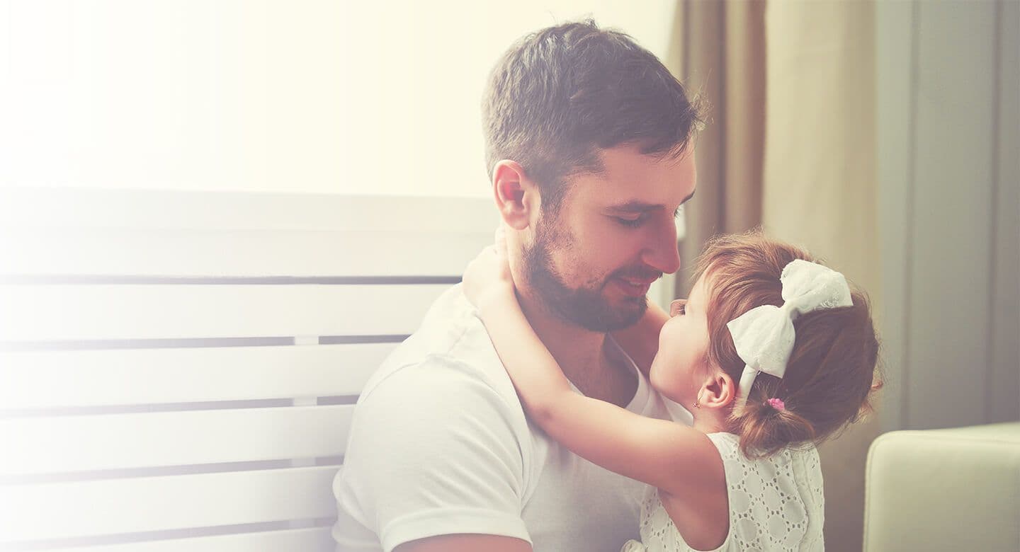 A parent holds a child.