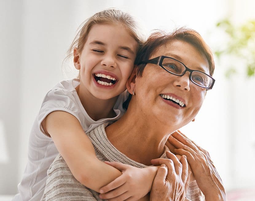A grandparent with a child on their back.
