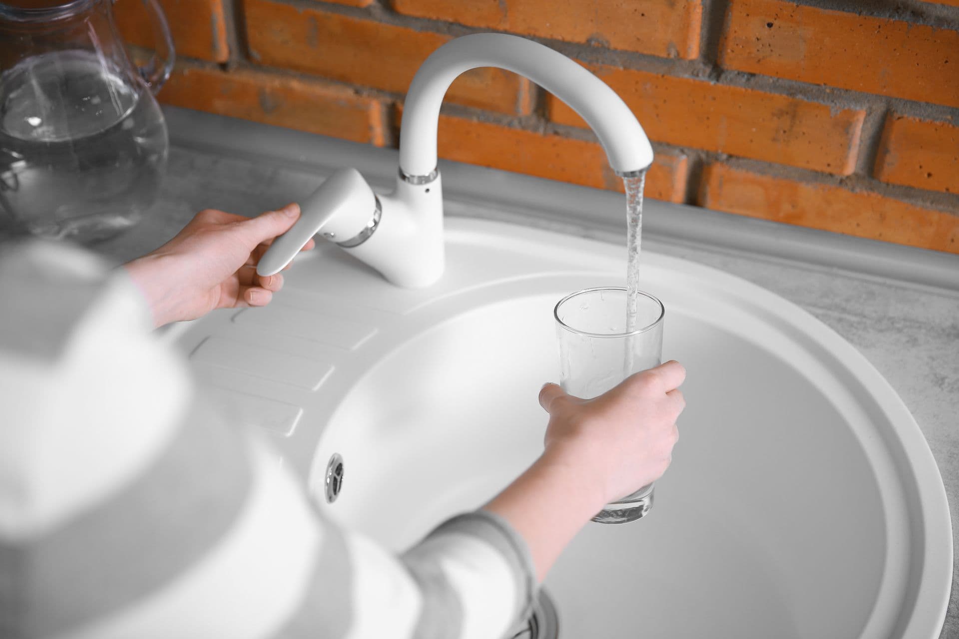 fewa-main-bigstock-Water-pouring-into-glass-in-pe-141777524.jpg