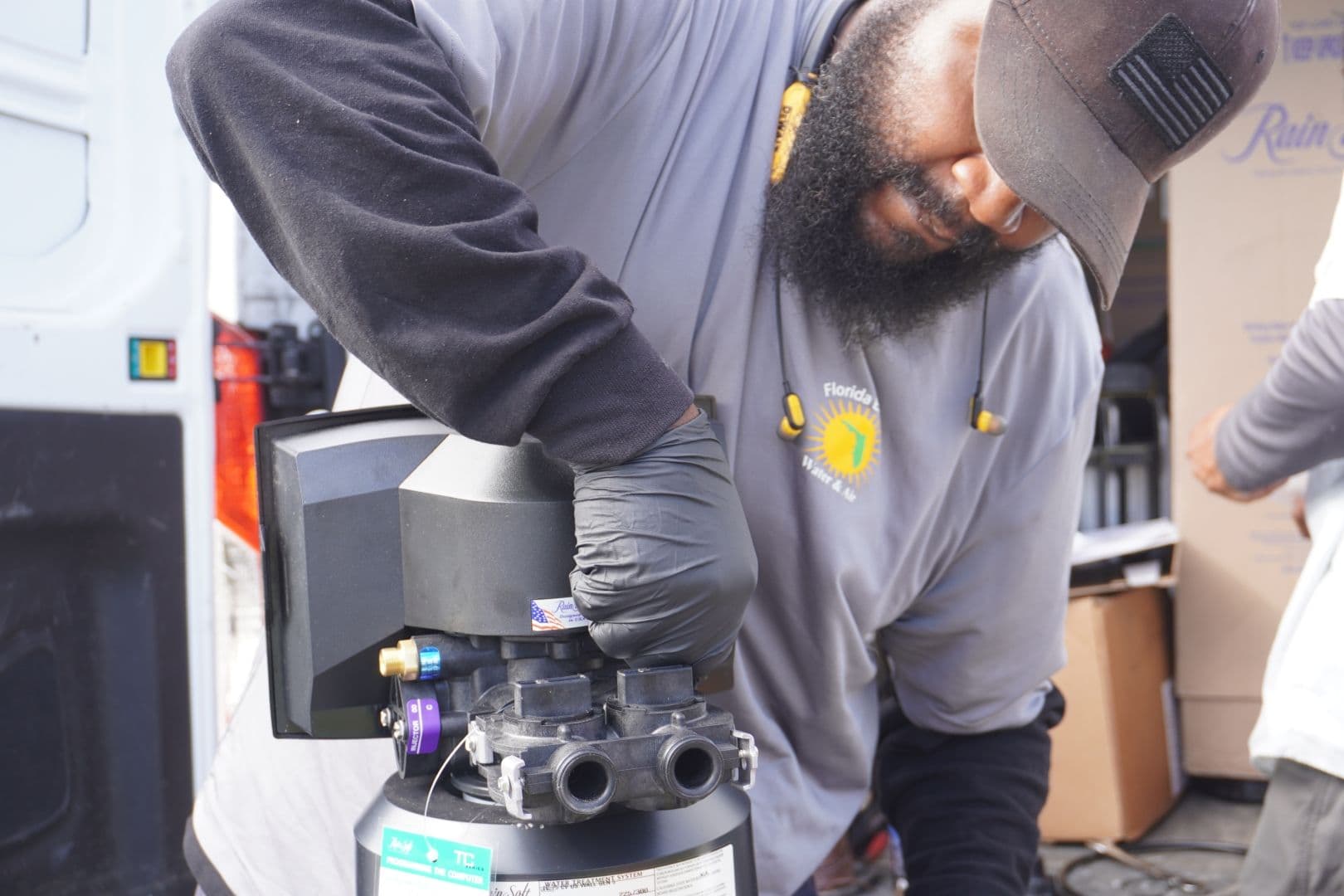 A FEWA employee installs a water treatment system.