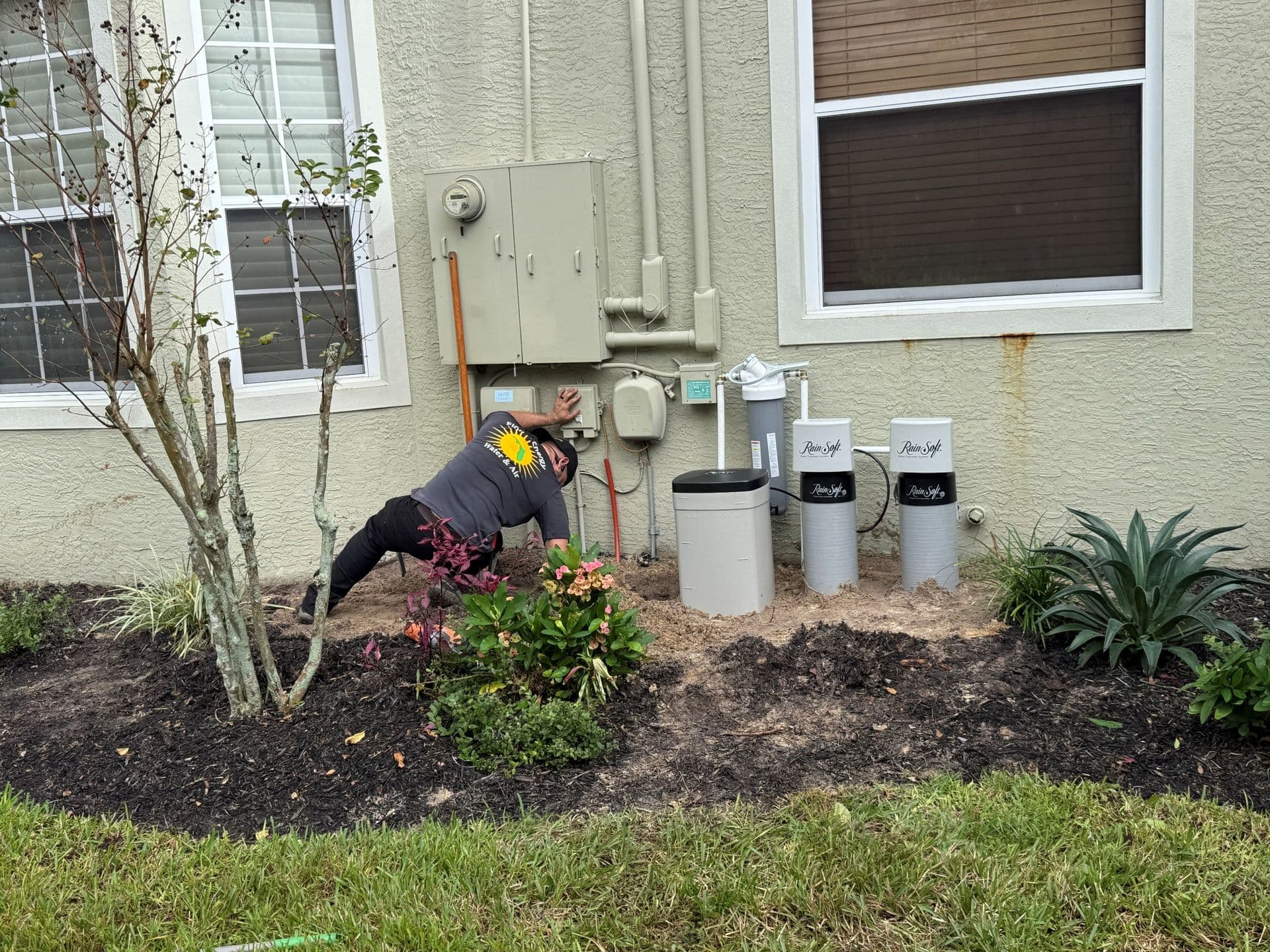 A FEWA employee installs a water treatment system.
